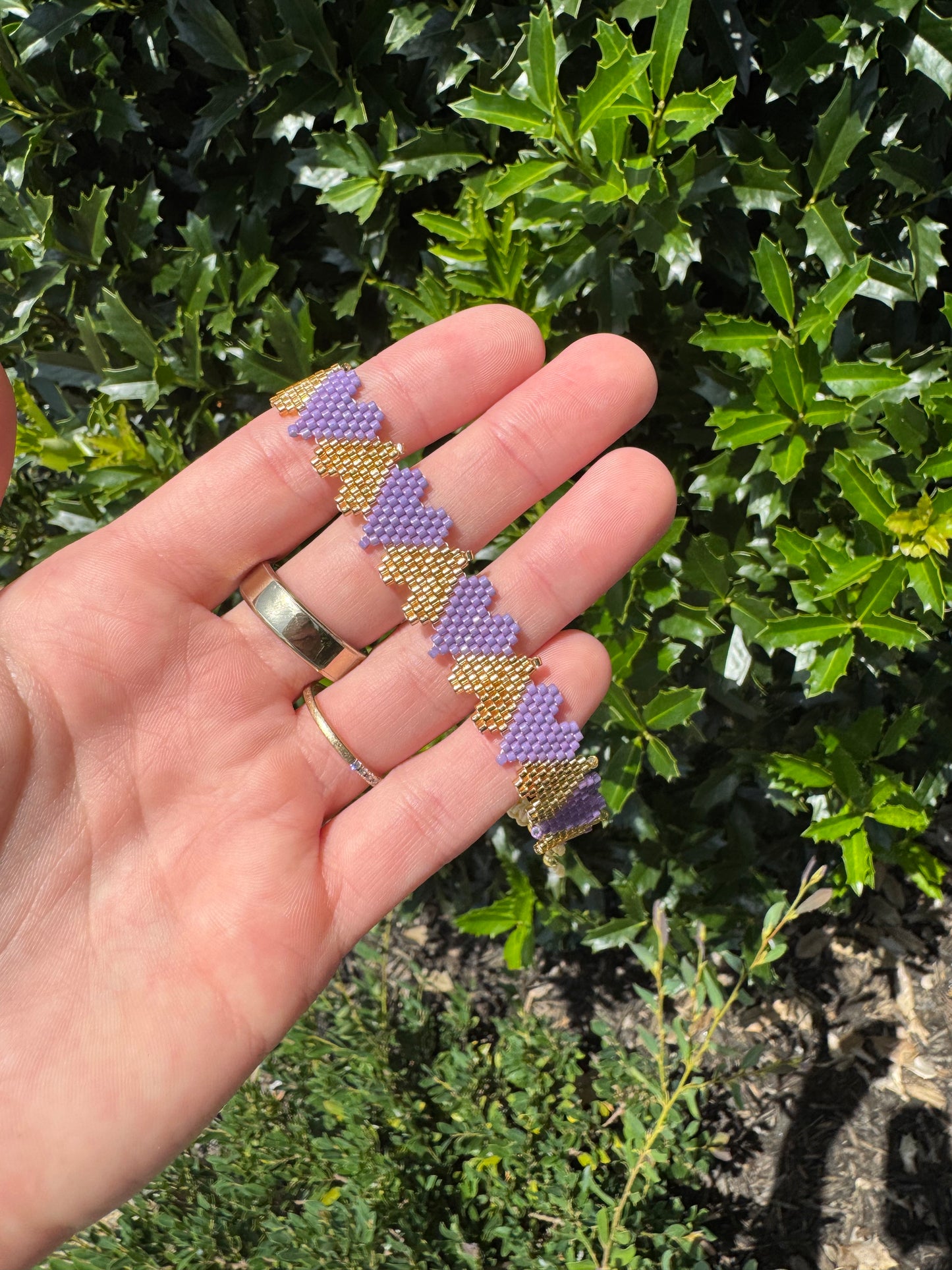 PURP AND GLD HEART BRCLT